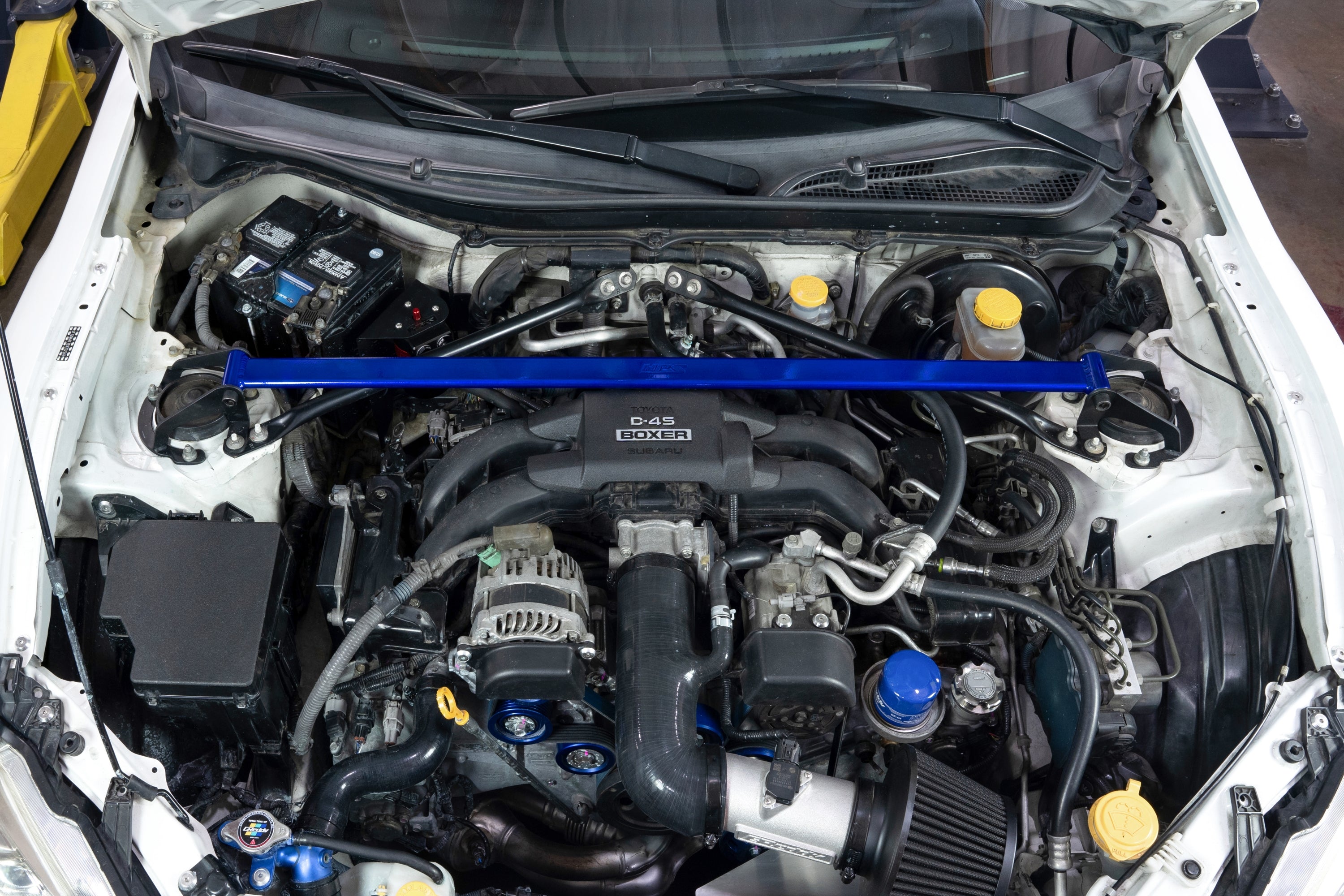 HPS Performance Blue Front Strut Tower Brace Bar installed on 1st 2nd Gen Toyota 86 GR86 ZN6 ZN8 Subaru BRZ ZC6 ZD8 Polished 42-121BL