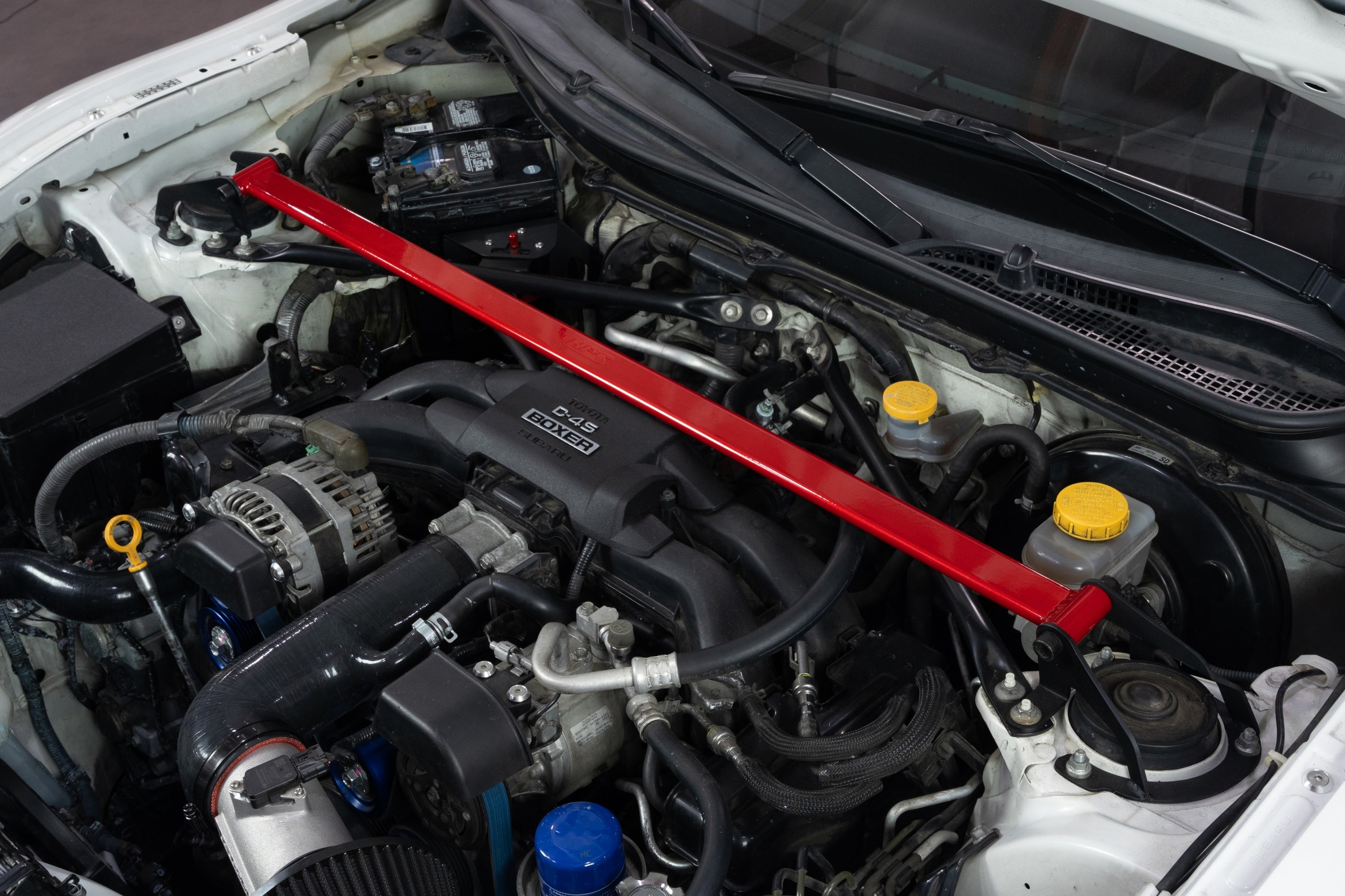 HPS Performance Red Front Strut Bar installed on Scion FR-S Toyota 86 GR86 Subaru BRZ Polished 42-121R