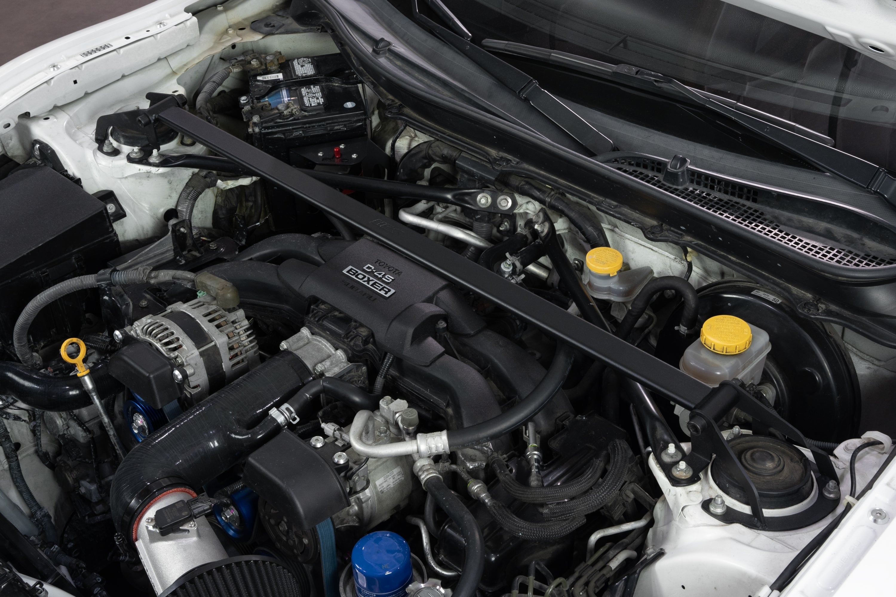 HPS Performance Black Front Strut Bar installed on Scion FR-S Toyota 86 GR86 Subaru BRZ Polished 42-121WB