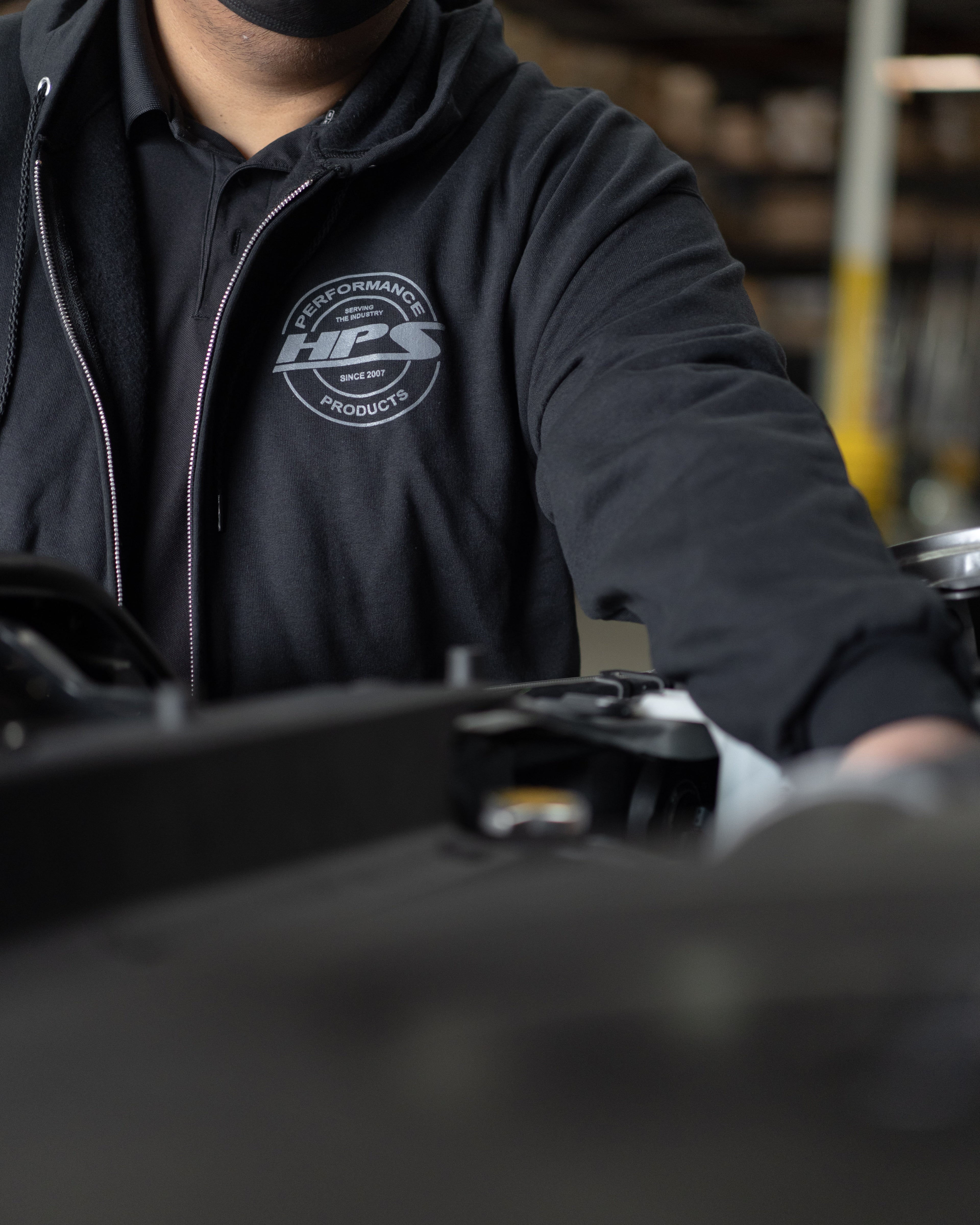HPS Performance Products Black zip up hoodie jacket round logo gray serving the industry since 2007 mens jacket drawstring hood small front logo pockets streetwear workwear